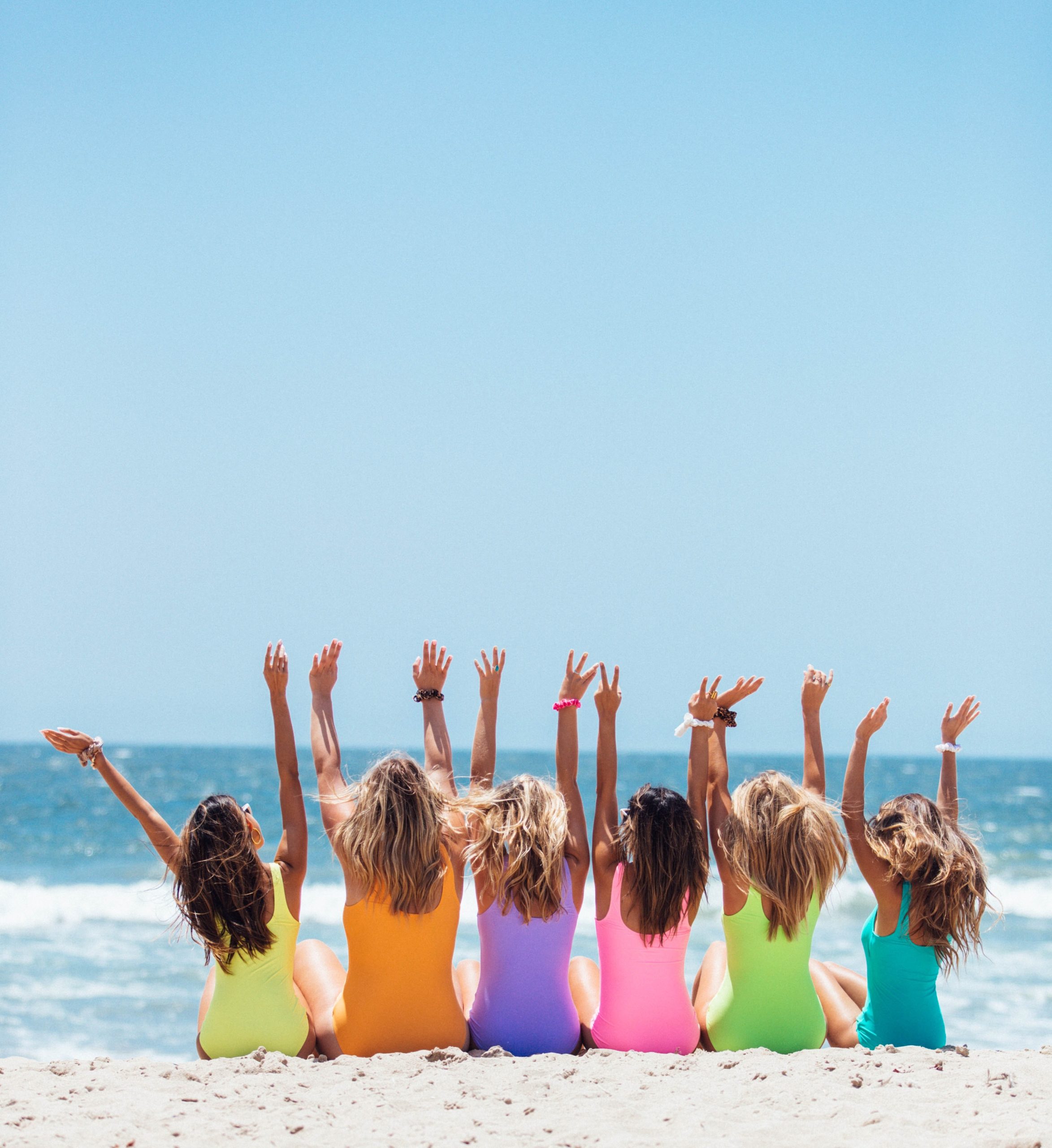 back-view-photo-of-six-girls-wearing-swimsuit-sitting-on-2647973