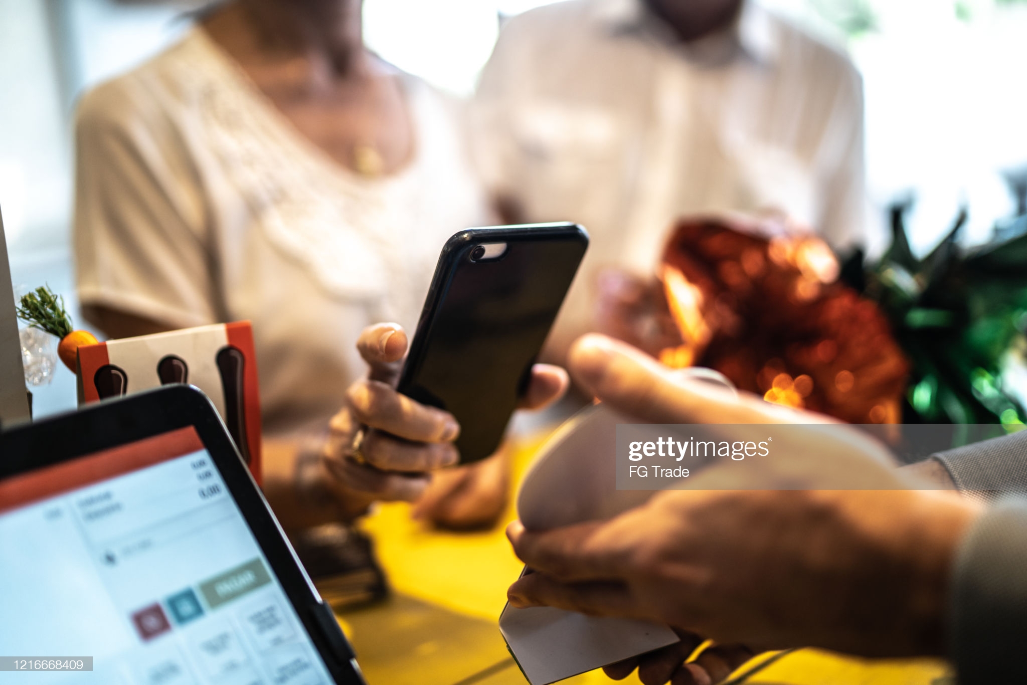 Senior woman paying by mobile in a store