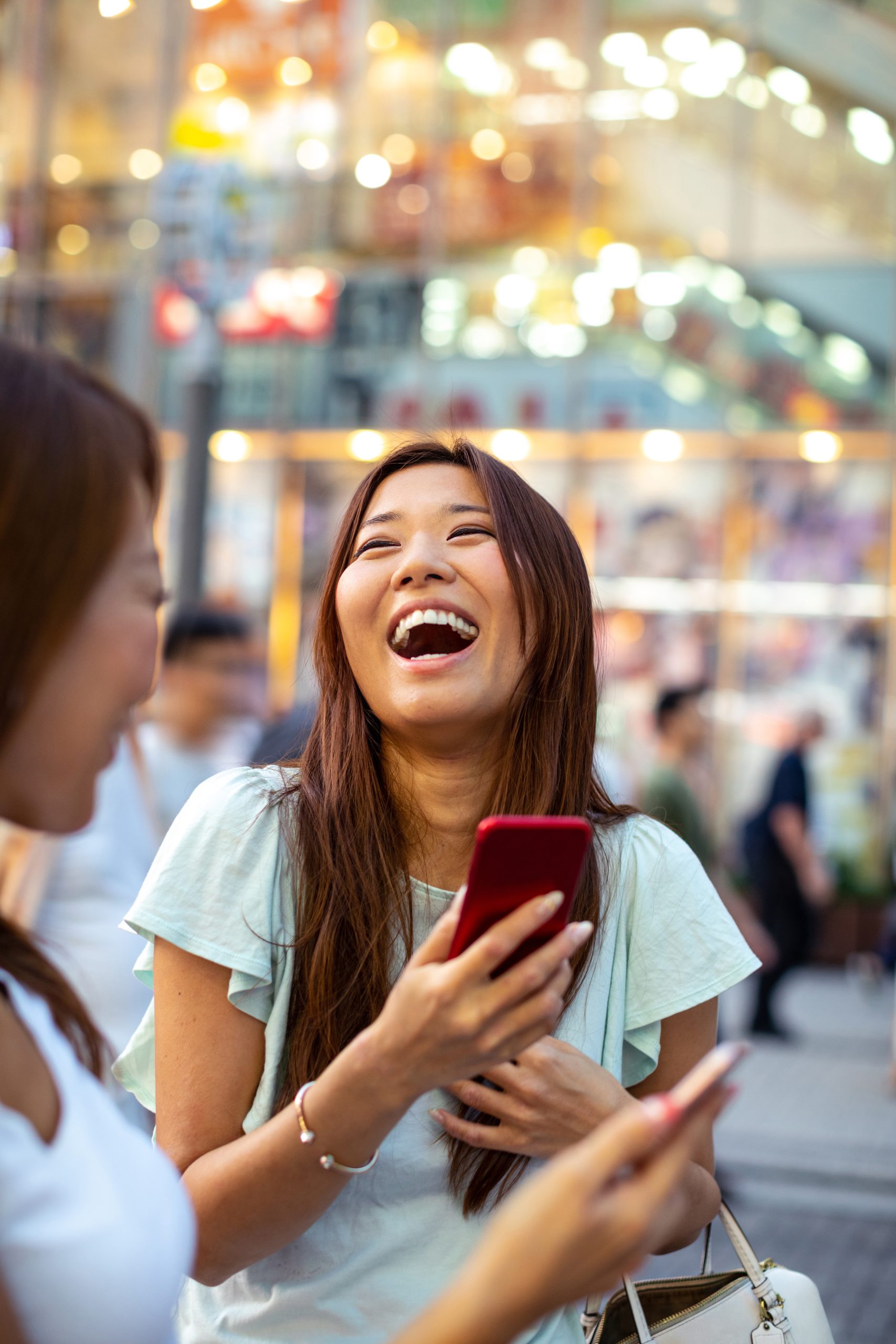 Women friends in Tokyo city streets, exploring and shopping in downtown