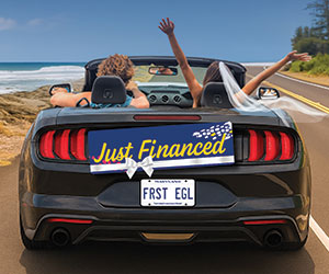 just-financed Married couple in getaway car with Just Financed banner on bumper.
