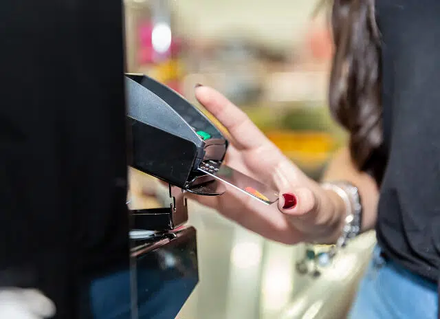 Woman inserting card into card reader