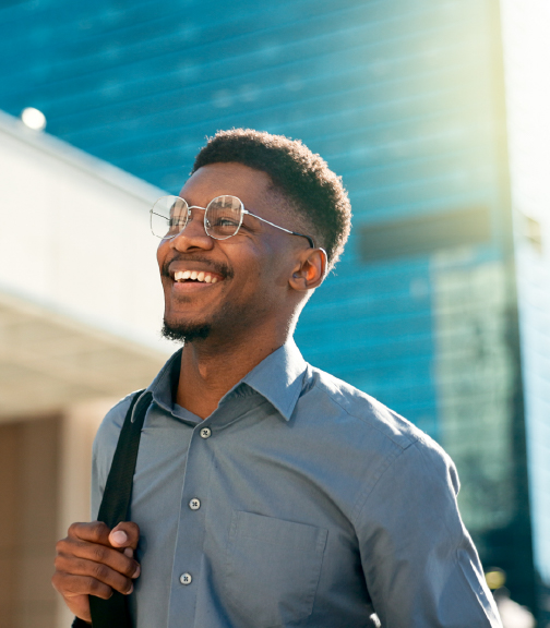 Smiling man outdoors wearing backpack