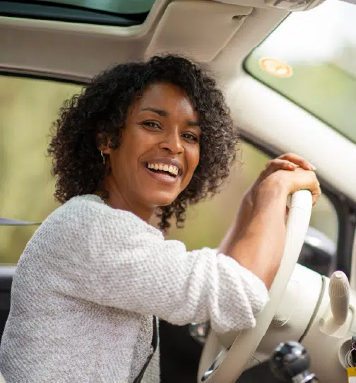 Woman leaning on steering wheel inside car