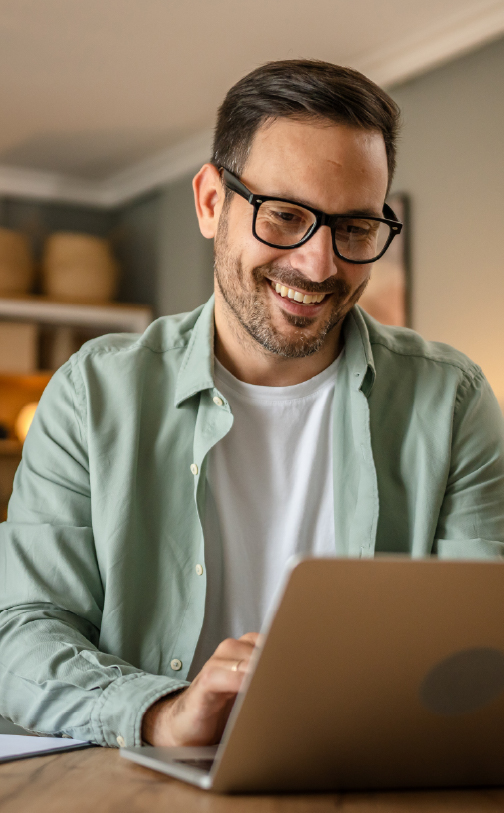 Man working on laptop and smiling