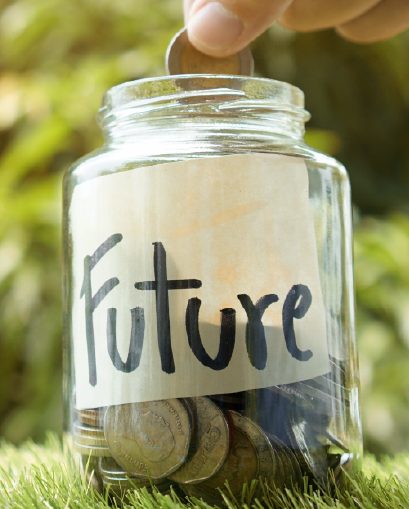 Hand placing coin in savings jar