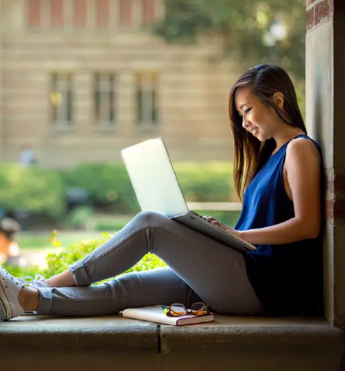 Woman working on laptop outdoors