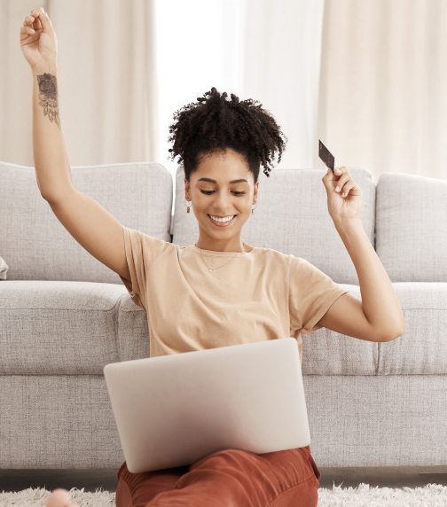 Woman celebrating success with laptop