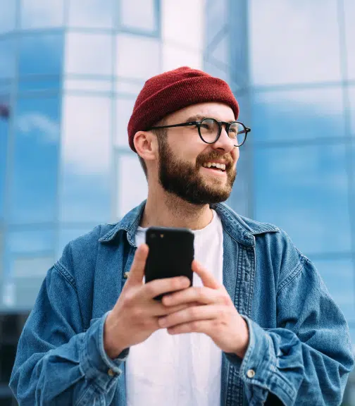 Man wearing beanie using smartphone