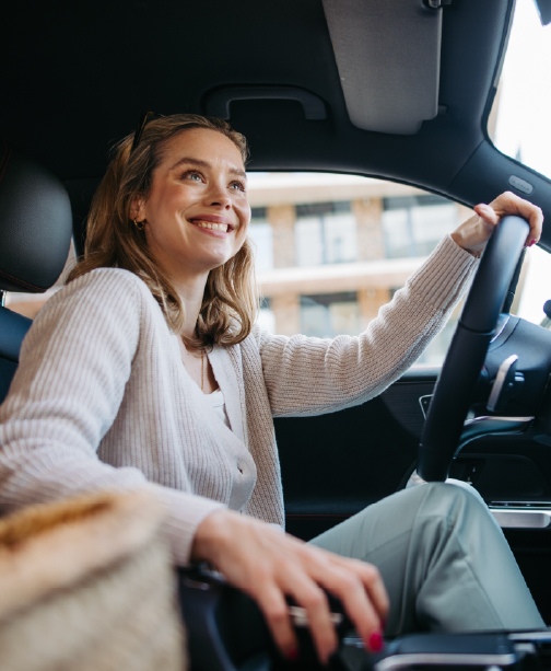 Woman driving car smiling