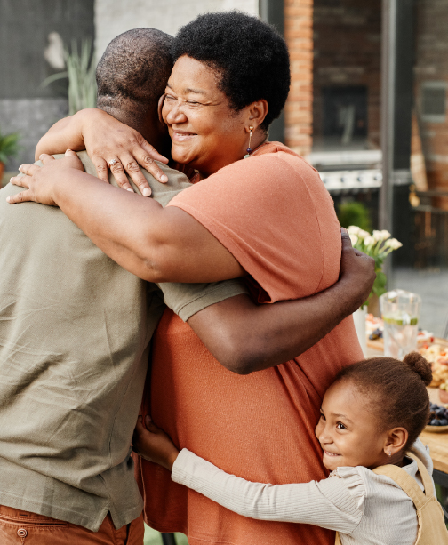 Family hugging at home