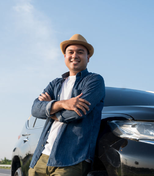 Man leaning on car smiling