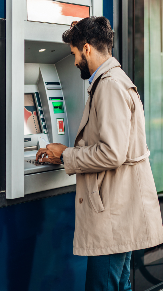 Person using ATM machine