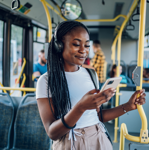 Woman using smartphone on public transit