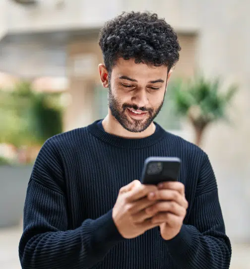 Man checking phone and smiling