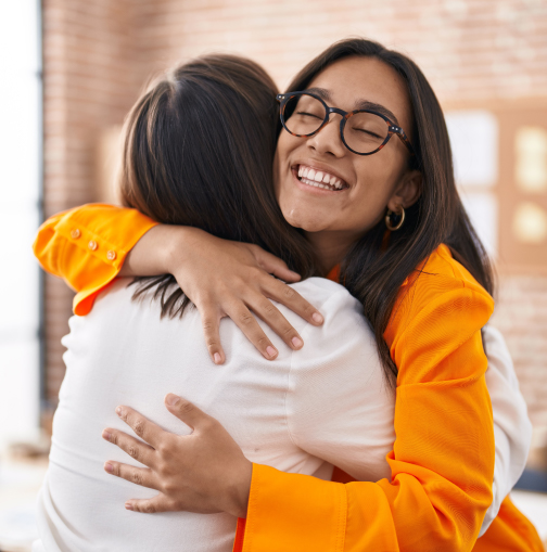 Two women giving eachother a hug