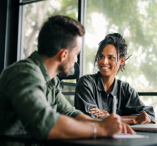 Two professionals talking across table