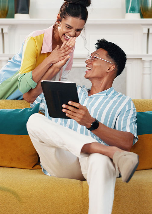 Man relaxing on couch using smartphone